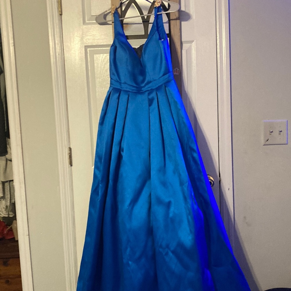A beautiful long blue prom dress it has gold leaf pins on the straps